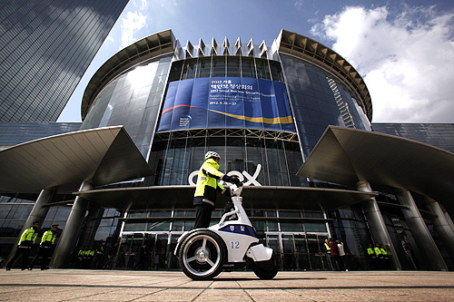 Policemen patrol in front of the COEX Convention and Exhibition Center, where the Nuclear Security Summit will be held, in Seoul.
