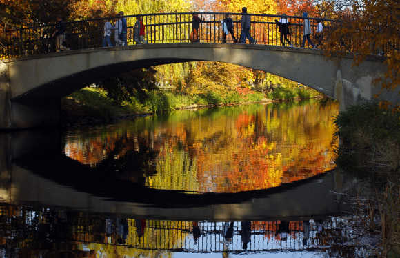 Children cross a footbridge in Boston.