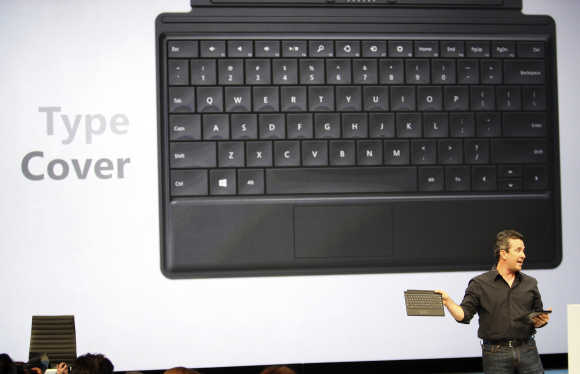 Microsoft's Corporate Vice-President of Windows Planning, Hardware and PC Ecosystem, Michael Angiulo, holds the Surface tablet computer and keyboard during his presentation as it is unveiled in Los Angeles, California.