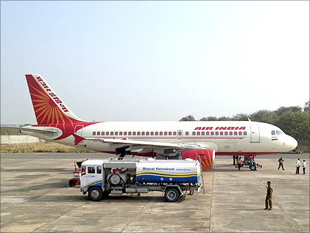 A Bharat Petroleum refuelling vehicle sits on the tarmac next to an Air India A320 aircraft.