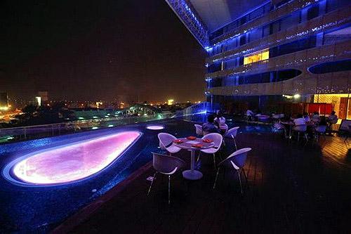 Customers sit at tables at Aqua, a bar popular with middle and upper class professionals, in Hyderabad, Andhra Pradesh.