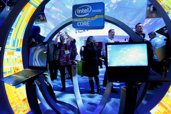 A woman takes a photo of ultrabooks at the Intel booth in Las Vegas.