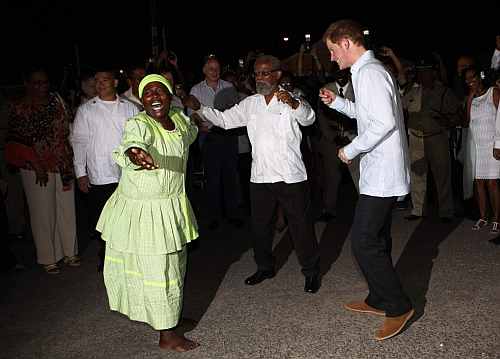 Britain's Prince Harry dances at a street party in Belmopan, Belize