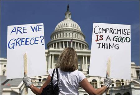 A demonstrator holds placards to protest U.S. debt in front of the Capitol in Washington.