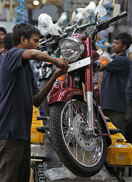 Workers assemble a Royal Enfield motorcycle inside its factory in Chennai.