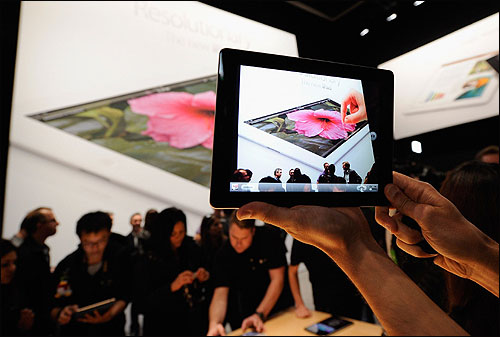 Members of the media preview the new iPad.