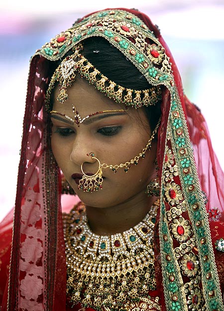 A bejeweled bride attends a mass marriage ceremony in Gujarat.