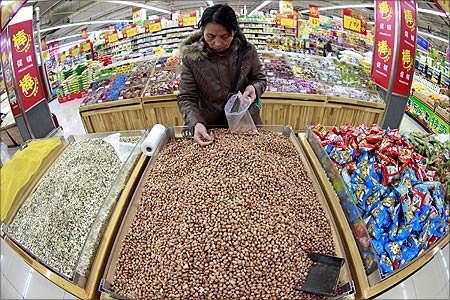 A customer chooses peanuts at a supermarket in Huaibei, Anhui province.