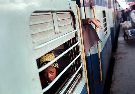 A girl peers out from a carriage at Nizamuddin Railway Station.