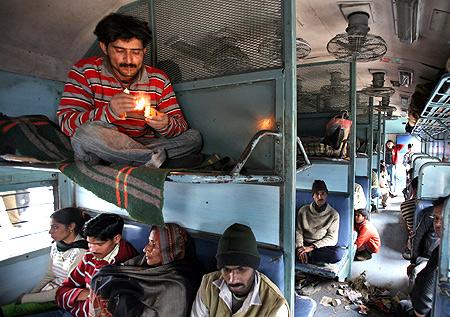 A commuter smokes inside a passenger train in Jammu.