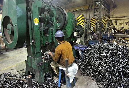 Men work inside a steel factory at Ludhiana in Punjab.