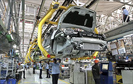 Workers assemble Ford cars at a plant of Ford India in Chengalpattu in the outskirts Chennai.