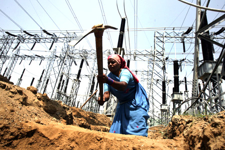 A labourer works at the construction site of a grid power station in Jammu.