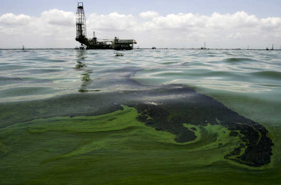 Oil spill on water is seen near an oil production facility at Maracaibo lake near the coastal town of Barranquitas, Venezuela.