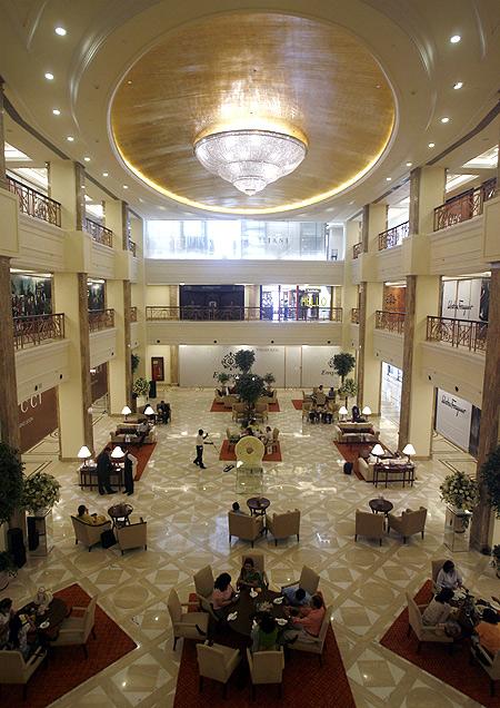 People sit inside a restaurant at the Emporio mall in New Delhi.