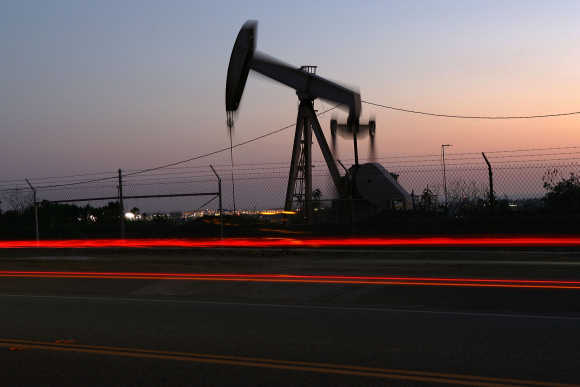 Car lights are seen streaking past an oil rig in Culver City, California.
