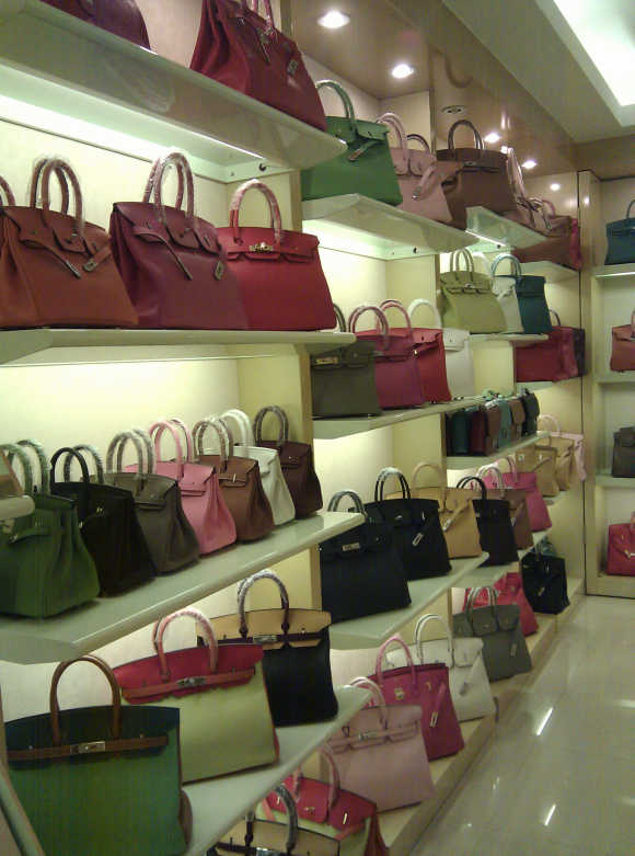 Fake foreign brand handbags are displayed inside a store at Baiyun World Leather Market in the southern Chinese city of Guangzhou.