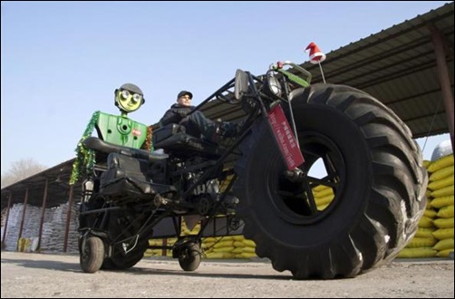 Zhang Yali, 49, tests a giant bicycle designed and made by him and his friends outside a rented warehouse in Jilin, Jilin province, China.