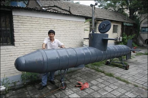 Tao Xiangli stands beside his homemade submarine in a courtyard in Beijing.