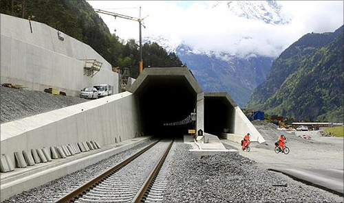 Workers cycle past the northern entrances of the NEAT Gotthard Base tunnel near Erstfeld (May 7, 2012).