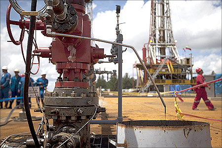 Crude oil drips from a valve at an oil well operated by Venezuela's state oil company PDVSA in Morichal.
