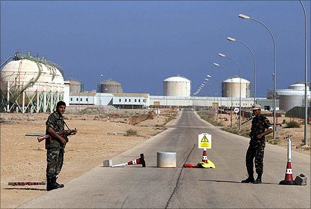 Armed National Transitional Council (NTC) fighters stand at a checkpoint at the Libyan Oil Refining Company (LERCO) in Ras Lanuf.