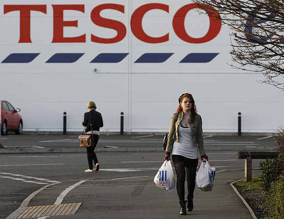 A shopper leaves a Tesco store in Loughborough, central England.