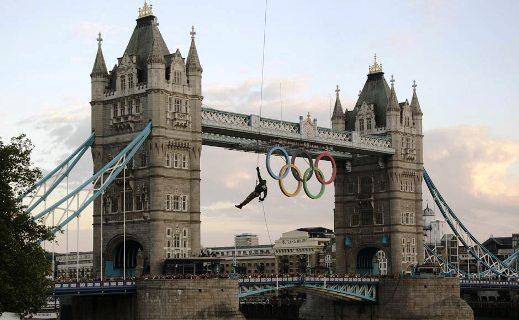 A British Royal Marine abseils from a helicopter with the Olympic Flame into the grounds of the Tower of London during Day 63 of the Torch Relay in central London.