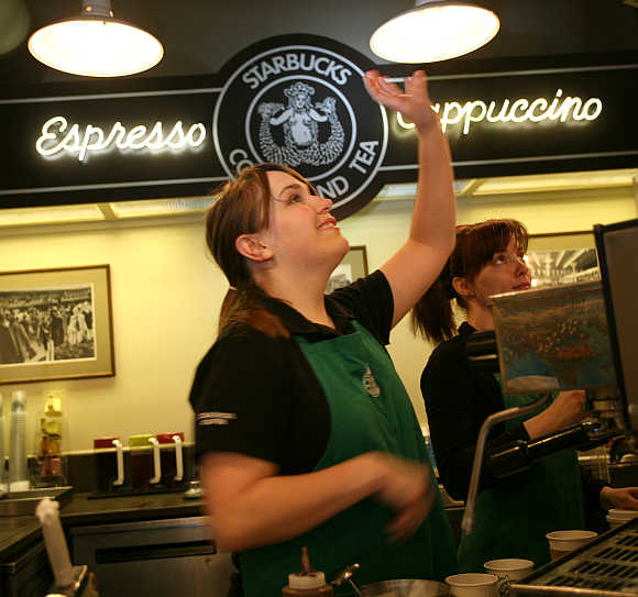 Robin takes an order at the first Starbucks store located at historic Pike Place Market in Seattle, Washington.