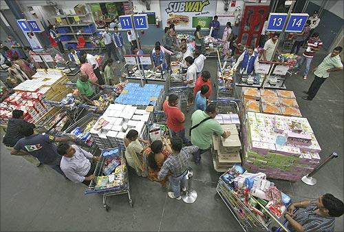 Customers wait to pay for their goods at a Best Price Modern Wholesale store, a joint venture of Walmart Stores Inc and Bharti Enterprises, at Zirakpur, Punjab