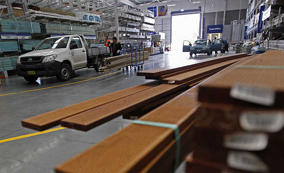 Customers load wood onto a truck in Sydney.