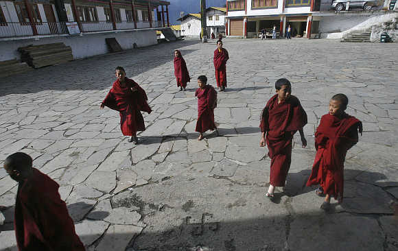 Child monks walk to attend morning prayers in Arunachal Pradesh.