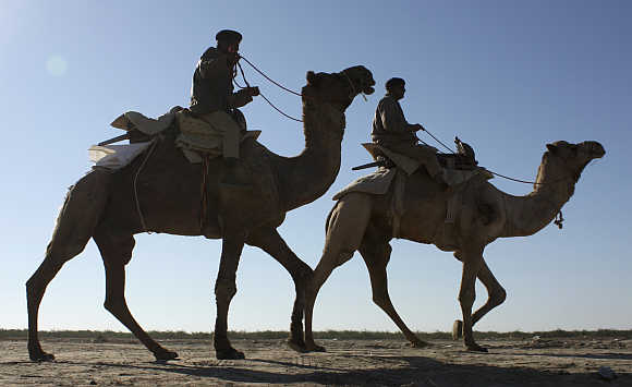 Indian Border Security Force personnel patrol at the white desert of the Rann of Kutch, Gujarat.