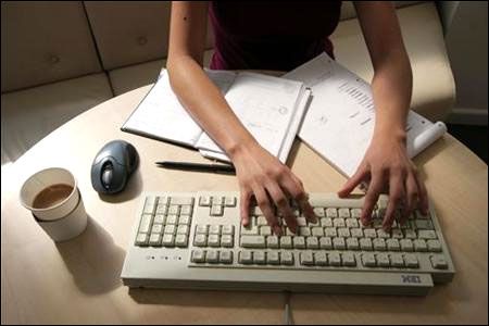 A woman works on a computer
