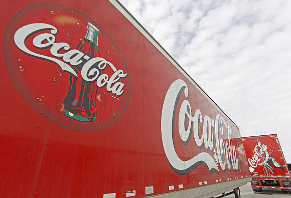 Trucks containing cases of Coca-Cola outside a warehouse at the Swire Coca-Cola facility in Draper, Utah.