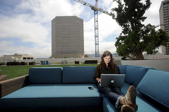 Jenna Sampson, a community relations manager at Twitter, works on the company's rooftop deck in San Francisco.