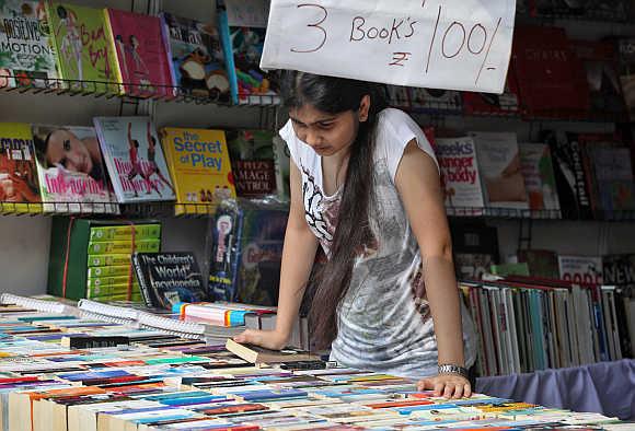 A girl looks at a book stall in Lucknow.