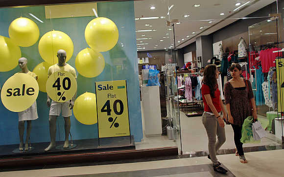 Shoppers exit a retail store inside a mall in Mumbai.