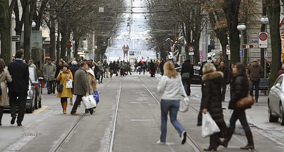 People walk on Zurich's main shopping street Bahnhofstrasse.