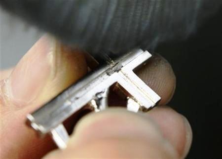 This file picture shows a worker polishing a platinum pendant head at Japanese jewellery brand, Ginza Tanaka's original equipment manufacturer factory in the Chiba prefecture, east of Tokyo.