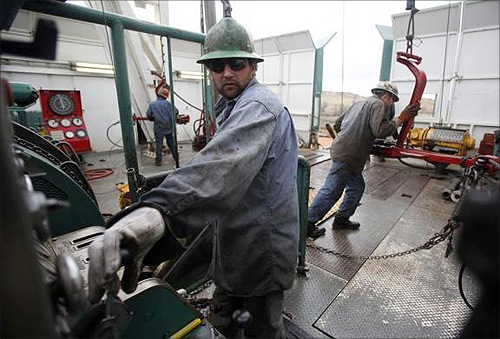 Roughneck Mike Wipf operates the drill on a True Company oil drilling rig outside Watford, North Dakota.