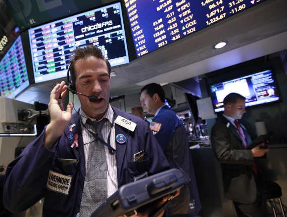 Traders work on the floor of the New York Stock Exchange.