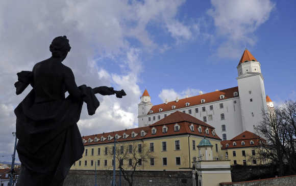 The 'Welcome' statue is seen in front of Bratislava castle in Bratislava.