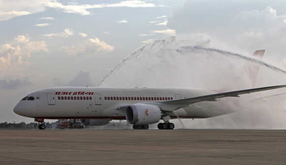 Air India's Boeing 787 Dreamliner is been given a traditional water cannon salute by the fire tenders upon its arrival at the airport in New Delhi.