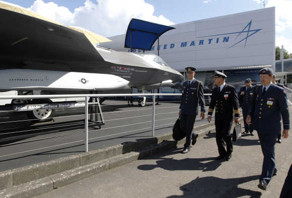 A Danish delegation walks pass Lockheed Martin's F-35 Lightning II at the Farnborough Airshow in southern England.