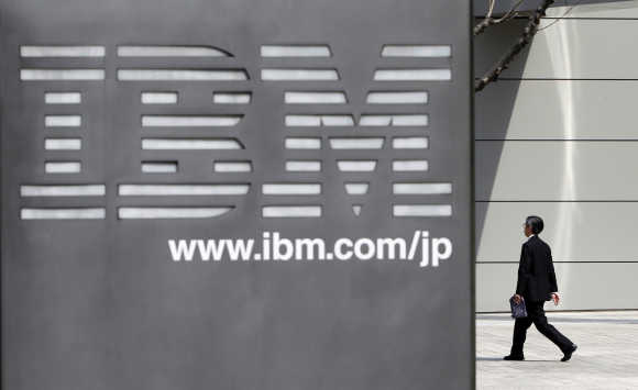 A man walks past the headquarters of IBM Japan in Tokyo.