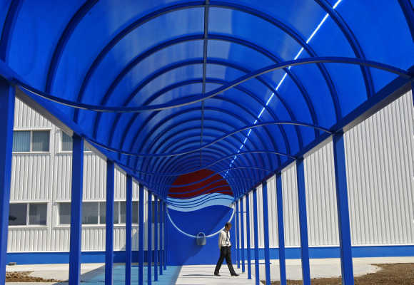 A security person walks past the entrance of the second-largest European Pepsi plant near Bucharest, Romania.