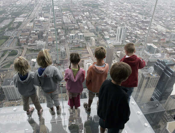 It is sometimes tough being Indian and trying to start a business, says Nemani. Children stand on 'The Ledge', a five-sided glass box 1,353 feet above the street in Chicago. The Ledge is part of Skydeck Chicago located on the 103rd floor of the Sears Tower.