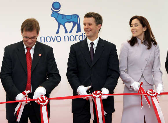Danish Crown Prince Frederik, centre, and his wife Crown Princess Mary, right, with Danish Deputy Prime Minister and Economy Minister Bendt Bendtsen, left, open Japan headquarters of Novo Nordisk in Tokyo.