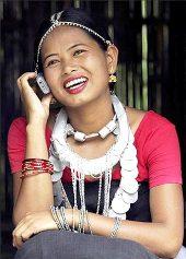 A girl from the Dhimal tribe, one of India's smallest tribal communities, talks on her mobile phone.